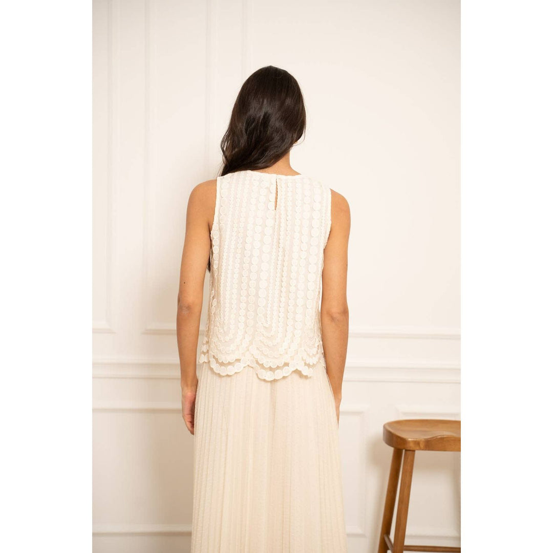 White lace sleeveless embroidered tulle top with scalloped hem and vertical pleating detail