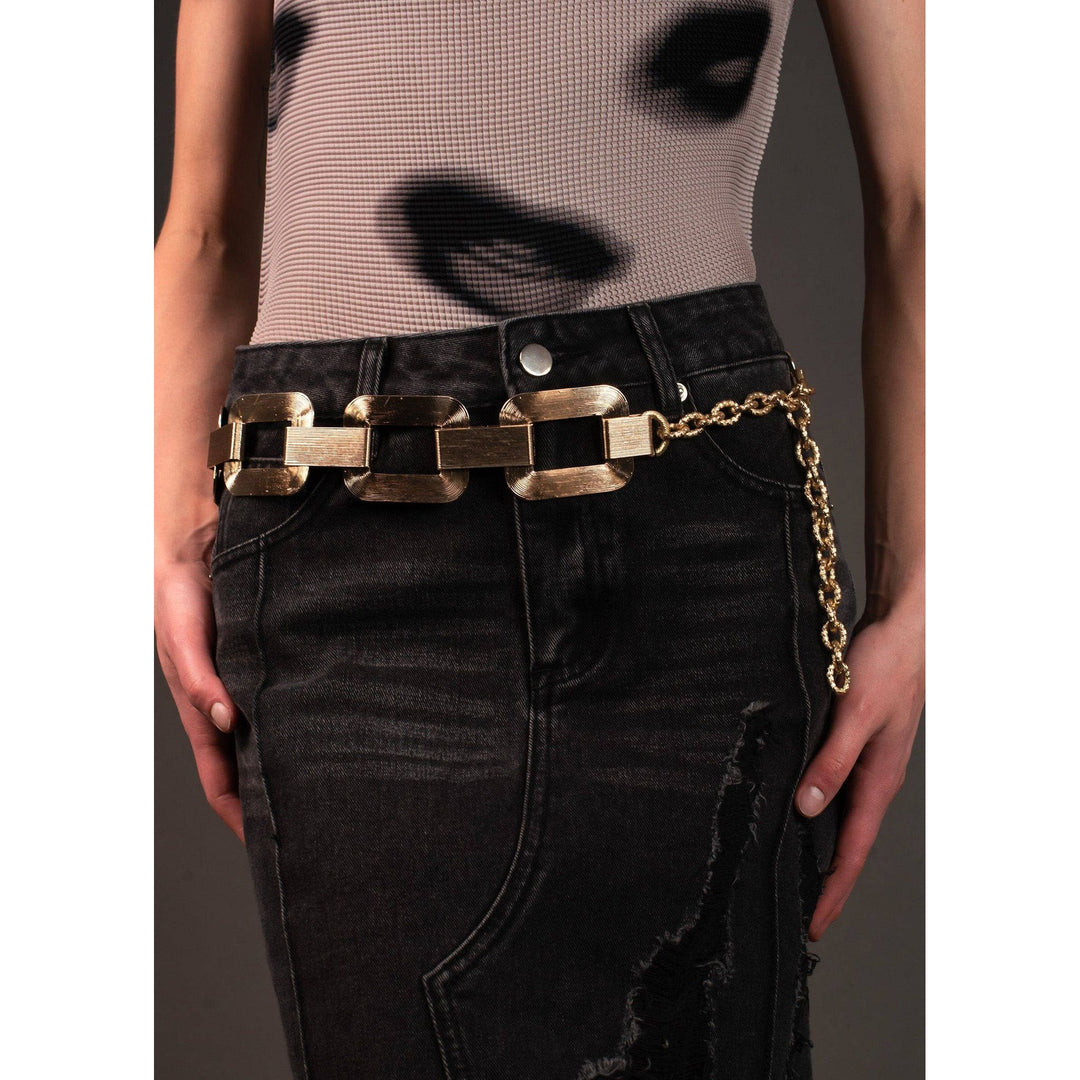 Large link chain belt in gold tone featuring rectangular metallic links and a dangling gold chain detail
