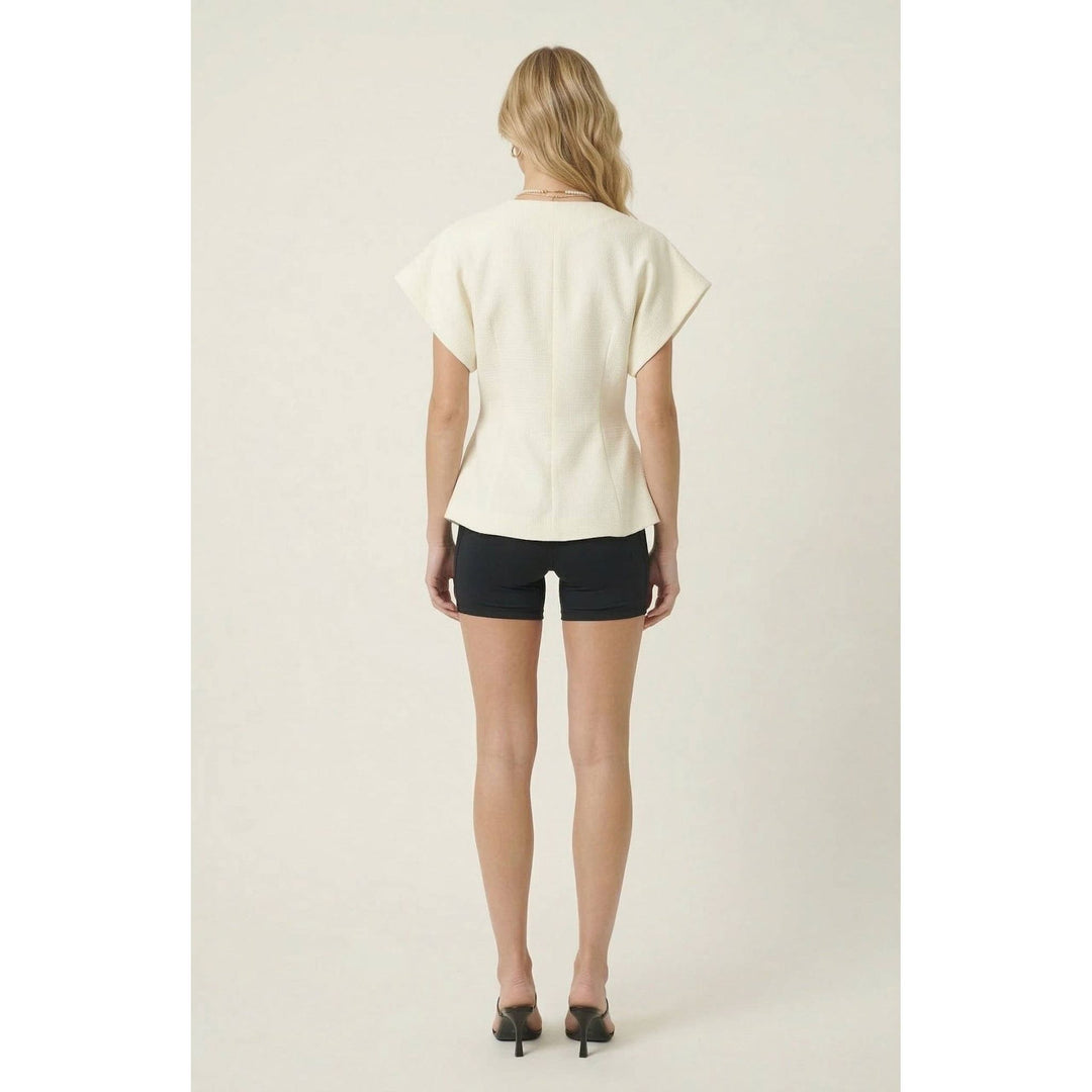 Off-white textured wrap top with short sleeves and peplum hem in relaxed fit for casual wear
