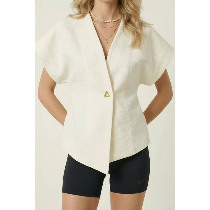 Off-white textured wrap top blazer with short sleeves draped front and asymmetrical hemline for stylish layering