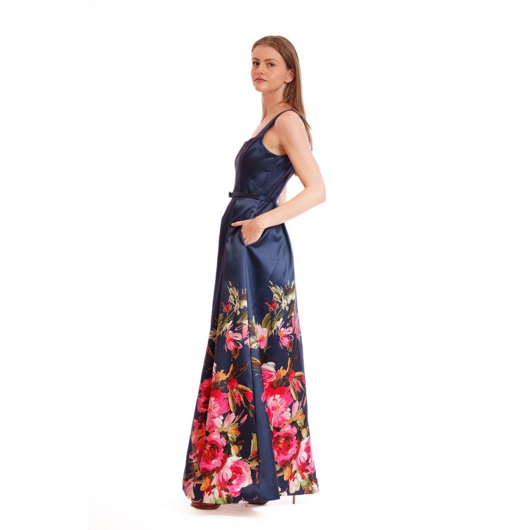 Navy blue satin evening bloom gown with vibrant pink and red floral pattern accented by green leaves