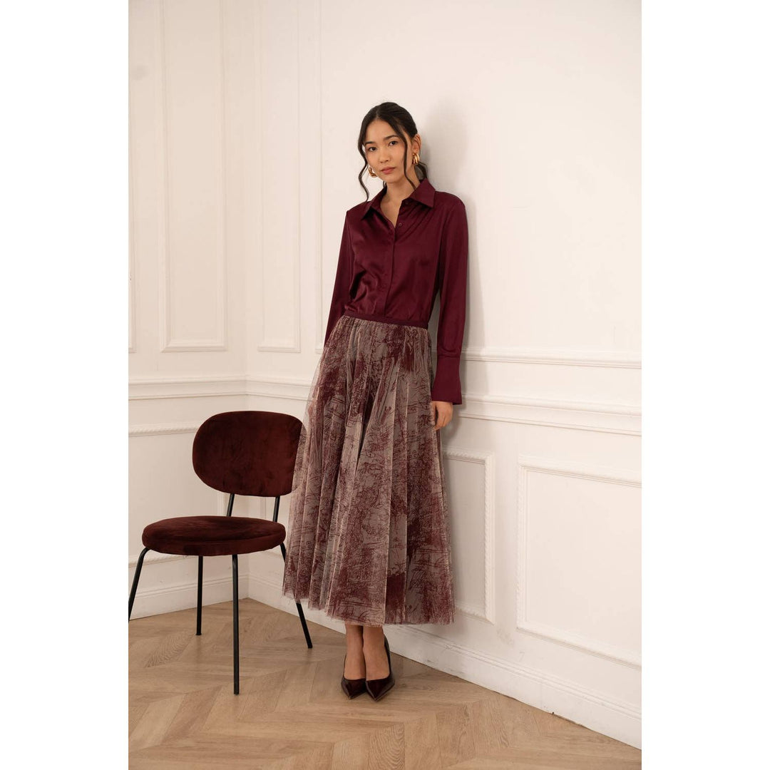A flowing sheer burgundy velvet midi skirt with a subtle textured pattern paired with a Lia satin shirt Bordeaux