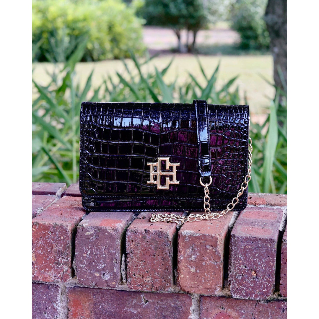 Bryn clutch black patent crocodile-embossed leather with gold-tone logo clasp and chain strap