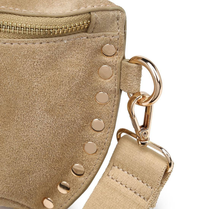 Beige suede crossbody gizelle belt bag with gold-tone studs and adjustable strap bone color