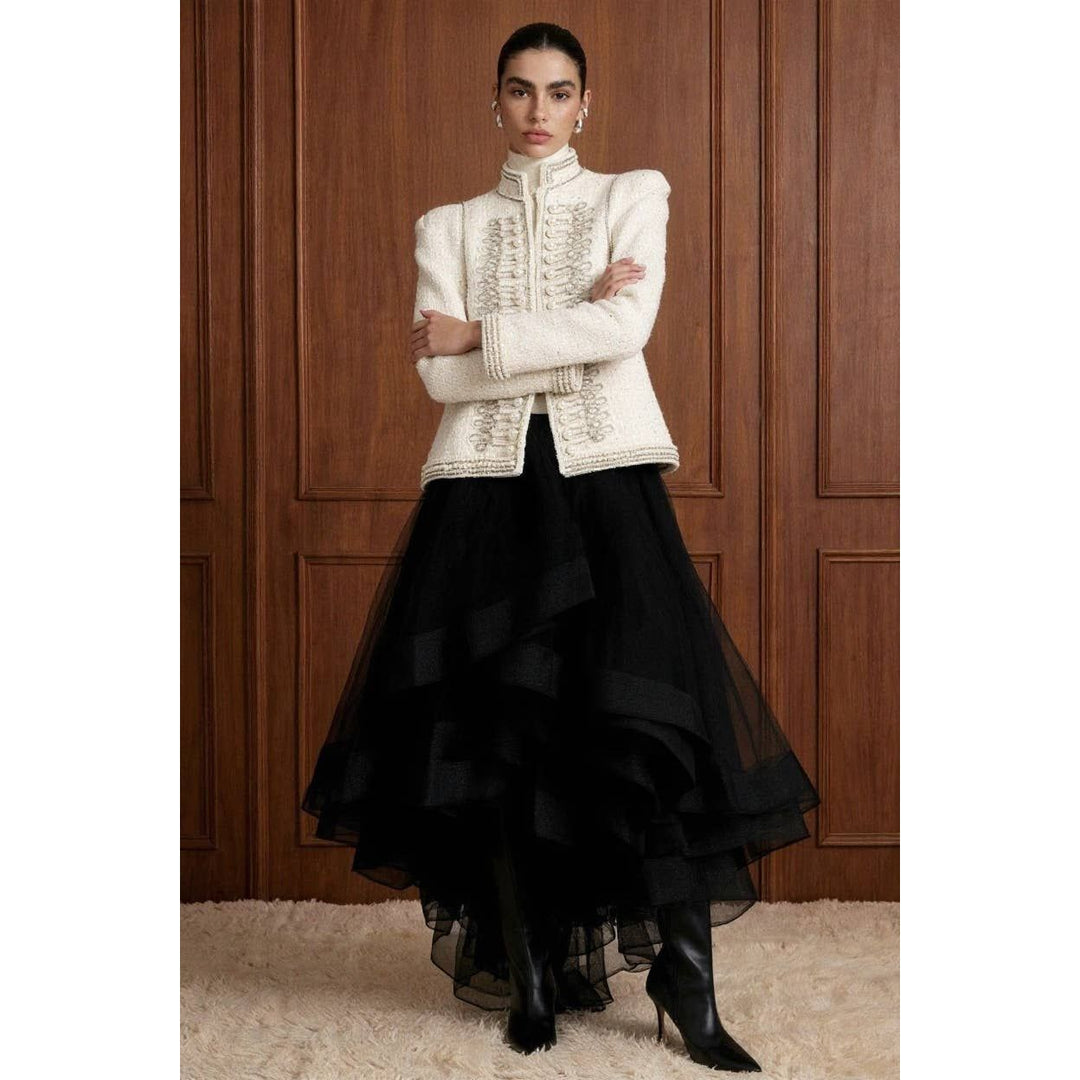 Cream-colored bouclé pearl embellished military jacket with intricate silver embroidery and structured shoulders