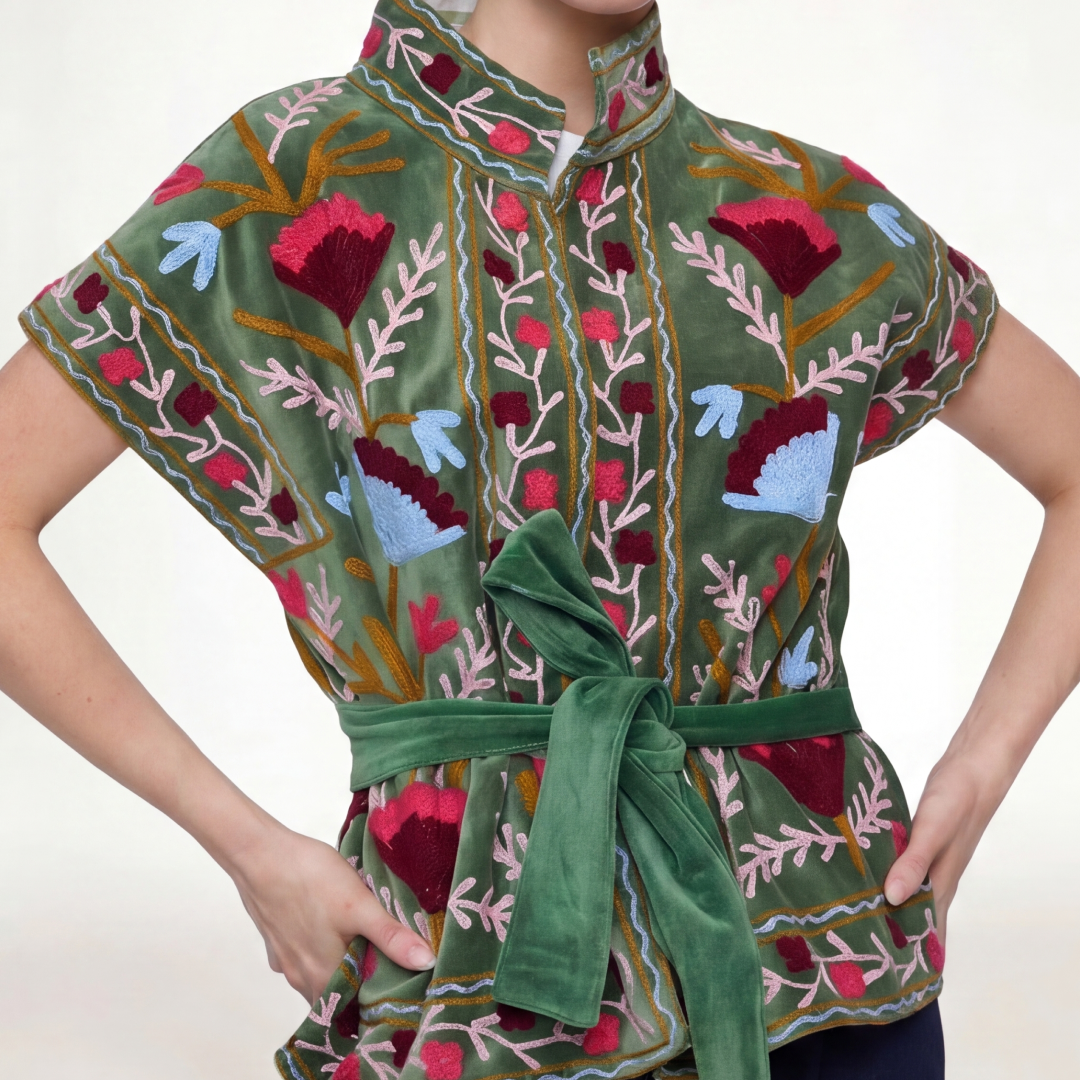 A vibrant green velvet Jaipur embroidered jacket with intricate red pink and blue floral embroidery
