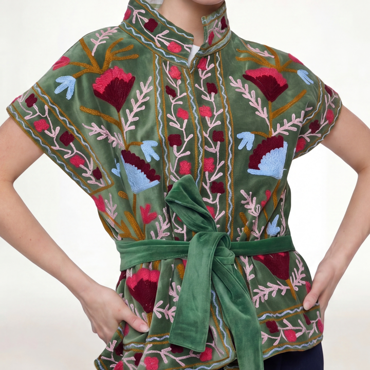 A vibrant green velvet Jaipur embroidered jacket with intricate red pink and blue floral embroidery