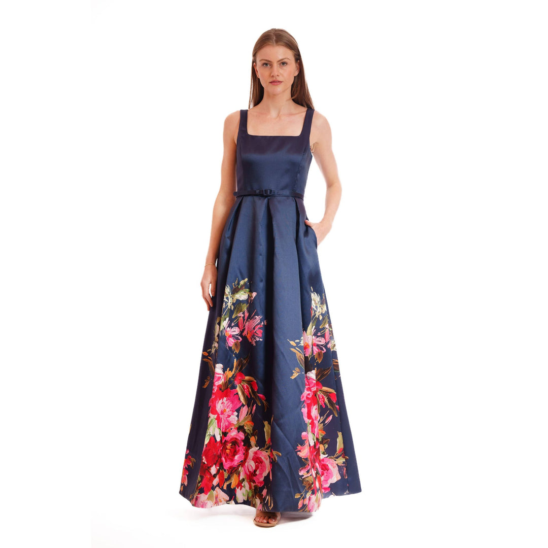 Navy blue satin evening bloom gown with vibrant pink and red floral print along the skirt hem