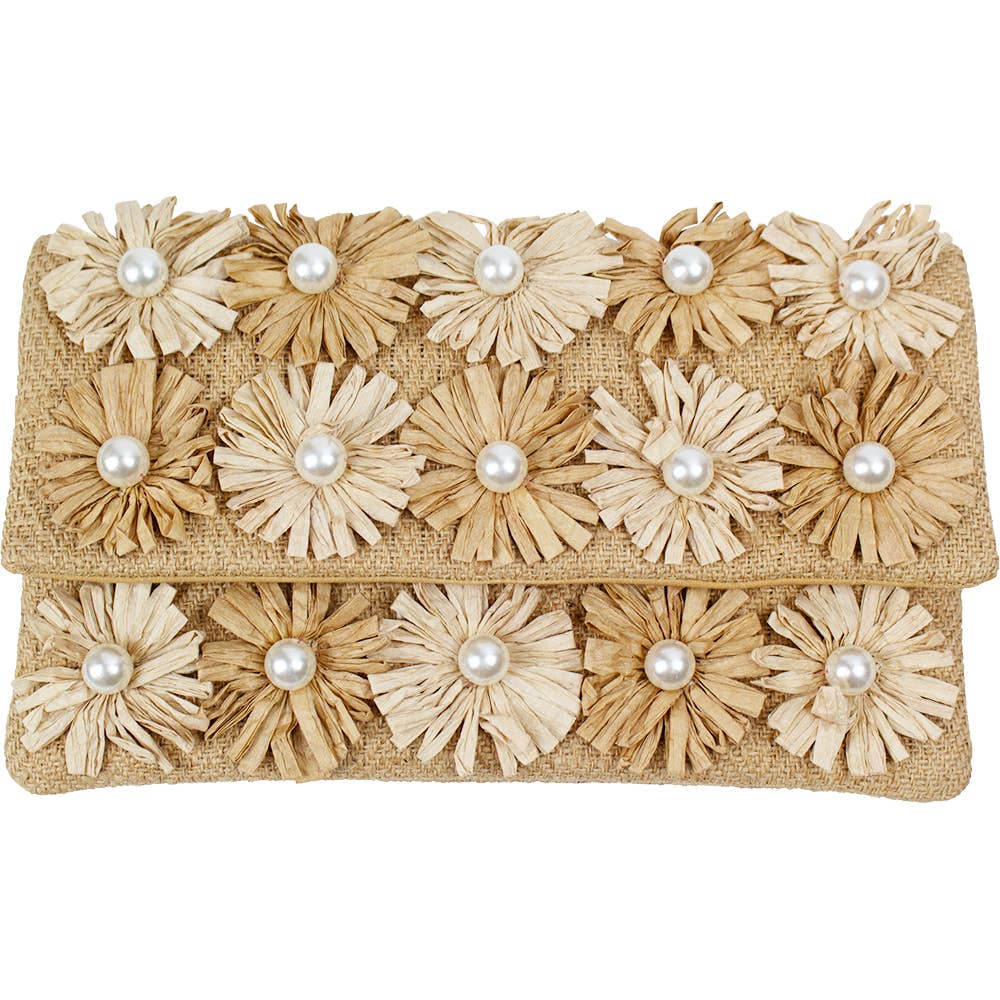Beige raffia clutch adorned with ten dimensional straw flowers each centered with a round pearl centerpiece