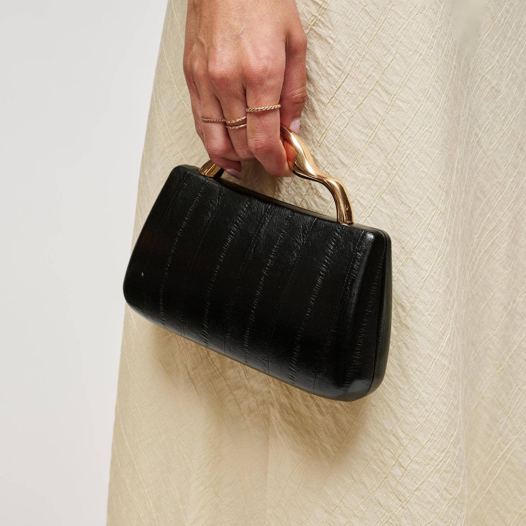 Nichelle clutch in black with black crocodile-embossed leather and a gold-tone twisted handle for elegant use