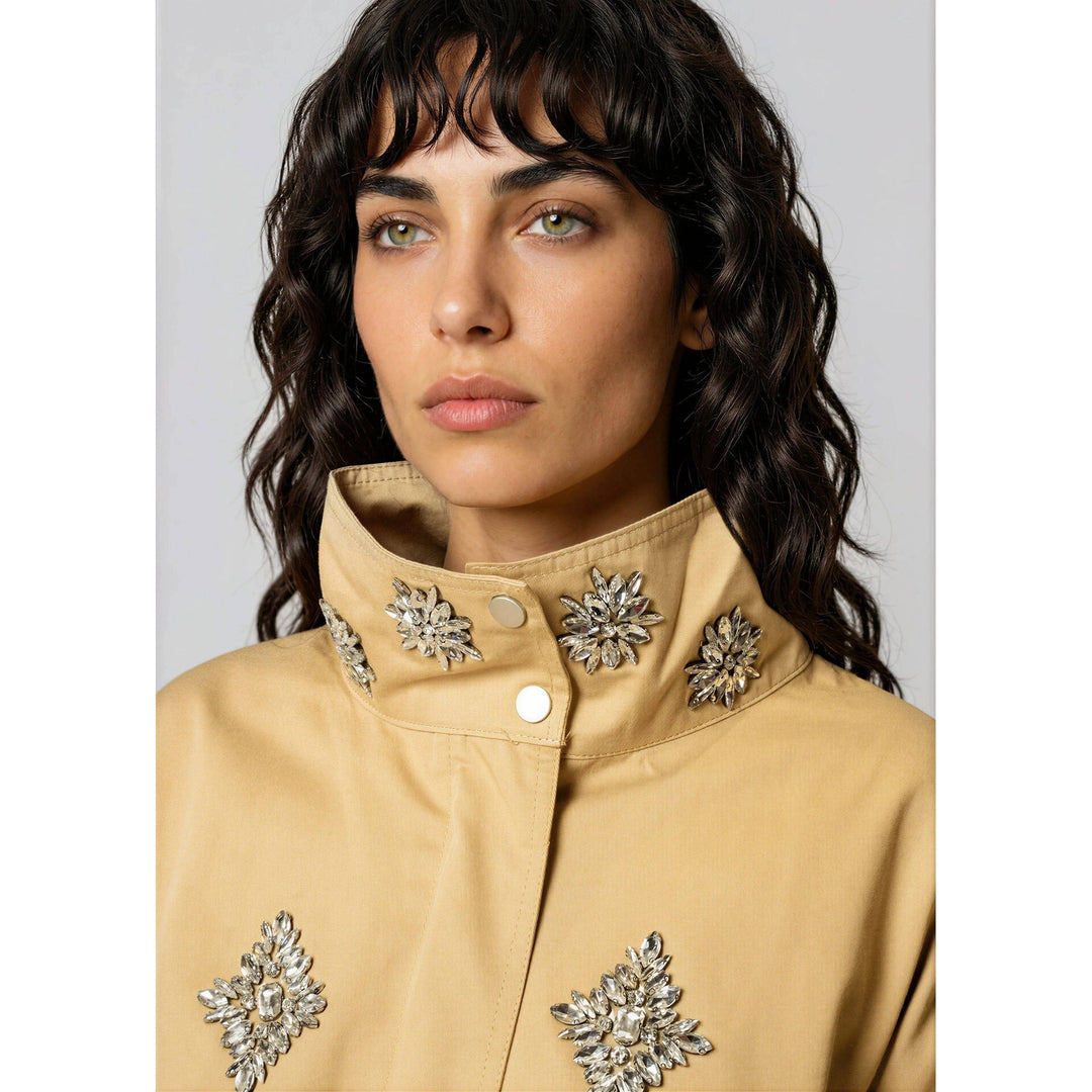 Beige crystal embellished utility jacket with silver floral embellishments on the collar and chest
