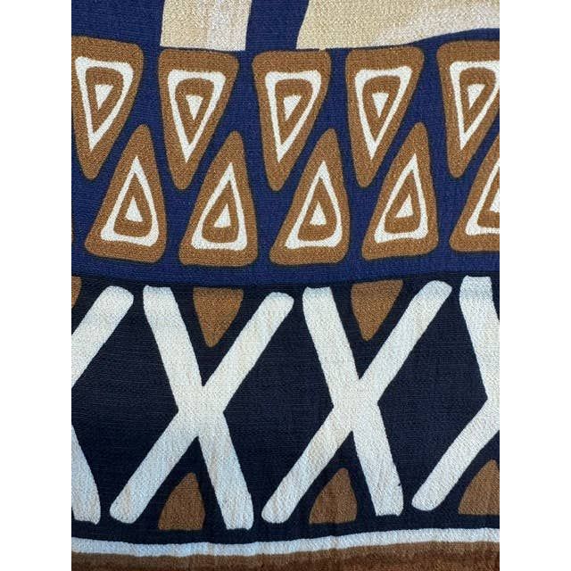 Mediterranean top with textured fabric featuring bold geometric patterns in navy blue brown and cream colors