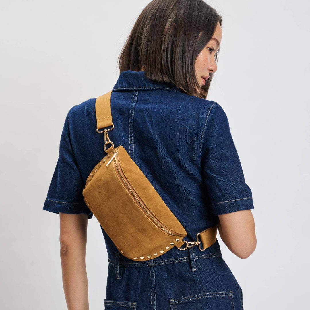 Tan suede gizelle belt bag with gold-tone metal studs and hardware for stylish hands-free carry