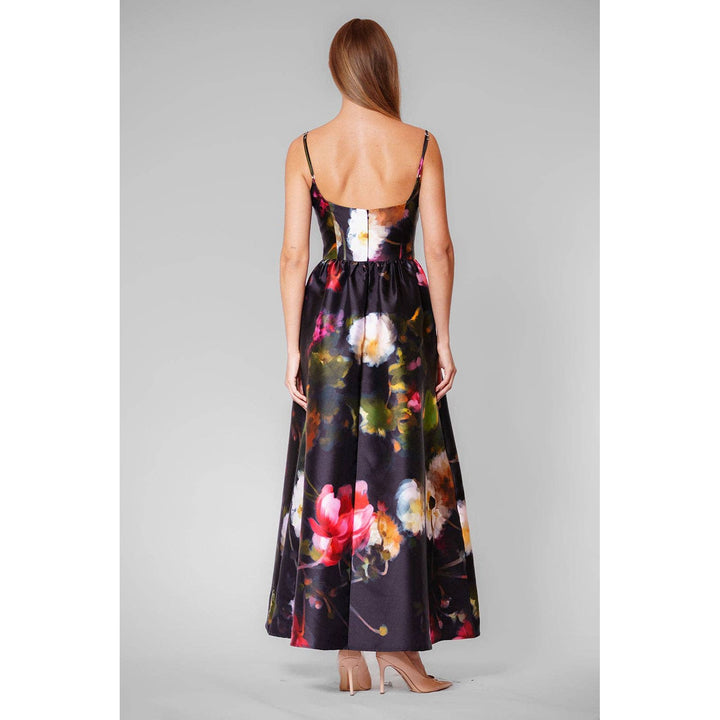 A flowing black satin maxi dress with vibrant pink white and green floral pattern called midnight garden gown