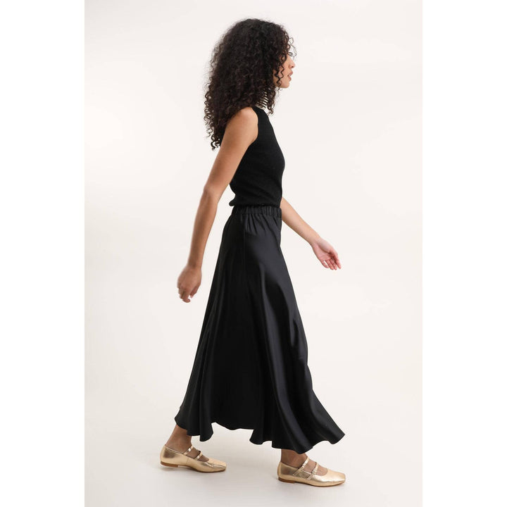 Valentina black satin maxi skirt with high waisted elastic waistband and flowing floor length silhouette
