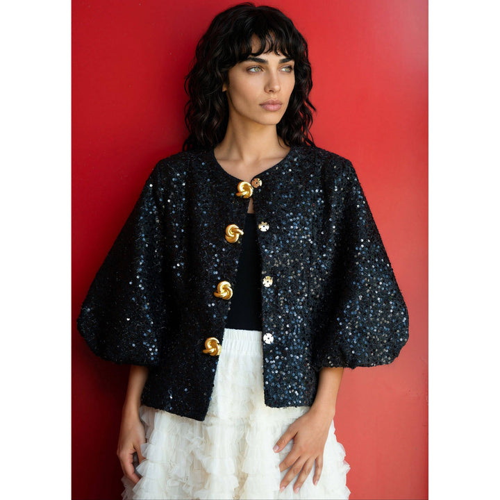 Black sequined tinsel balloon sleeve jacket with cape style and gold tone twisted button closures