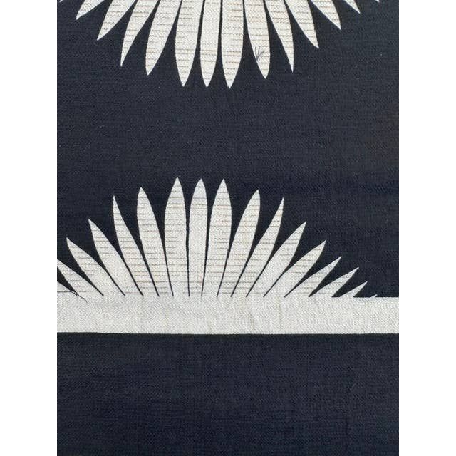 Black fabric with a repeating white sunburst pattern on the lunar bloom maxi dress