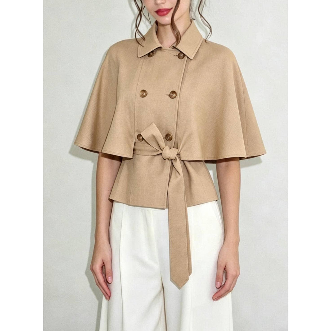 Beige double-breasted cape top with tied waistband and gold-toned buttons in a soft fabric design