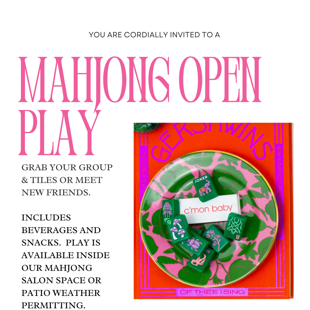 Green and purple floral design mahjong tiles rest on a pink plate in open play mahjong set