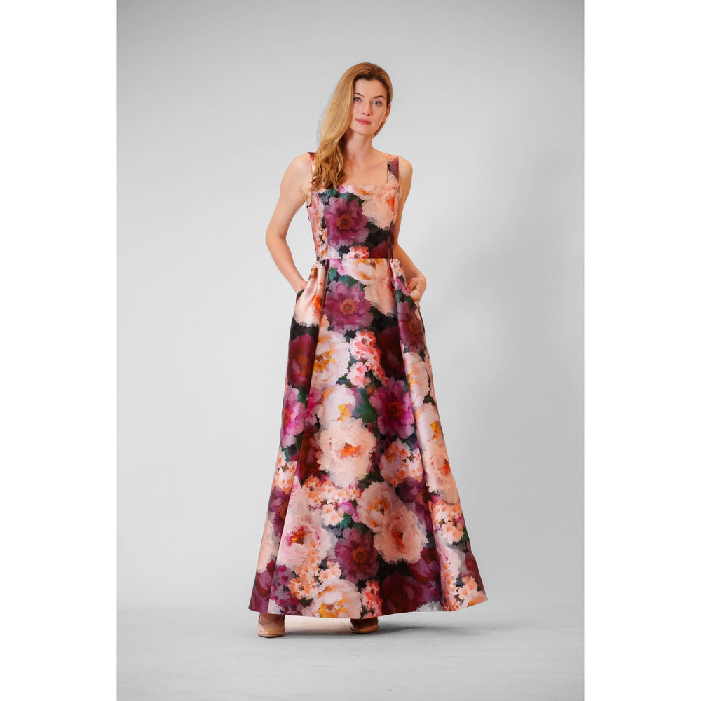 A flowing floor-length mikado autumn floral gown with vibrant pink purple and orange flowers on a dark background