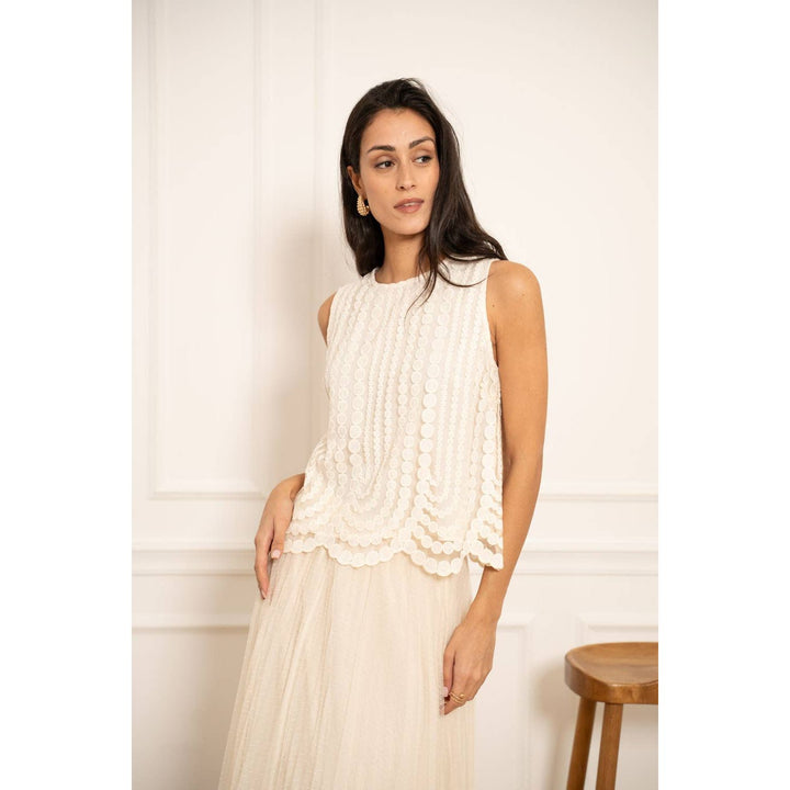 White sleeveless embroidered tulle top with textured ruffles and scalloped hemline for elegant occasions