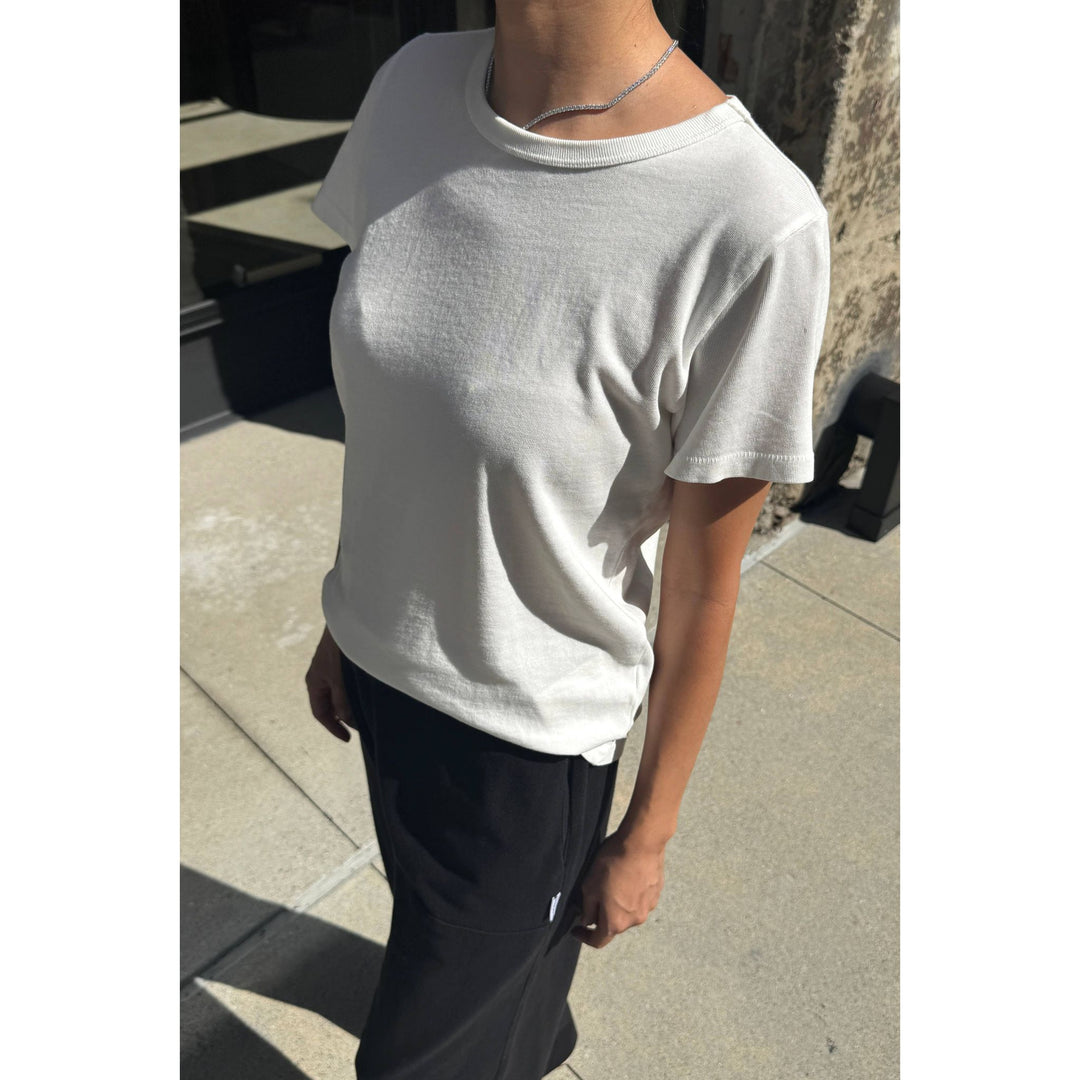 The go-to premium tee white is a soft off-white cotton t-shirt with a relaxed fit and ribbed crew neckline