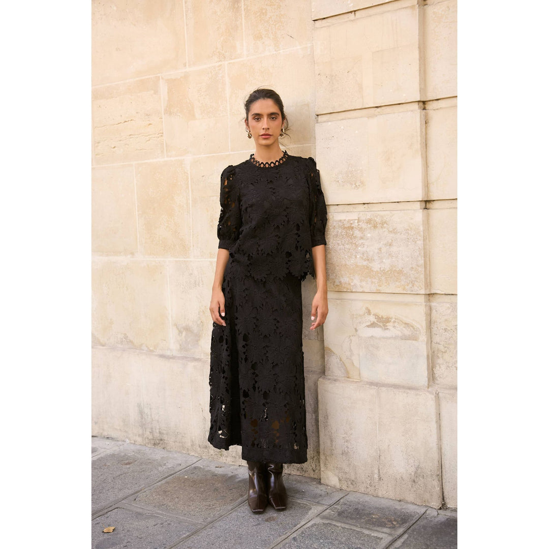 Black lace dress with three quarter sleeves and high neckline featuring daisy guipure skirt detail