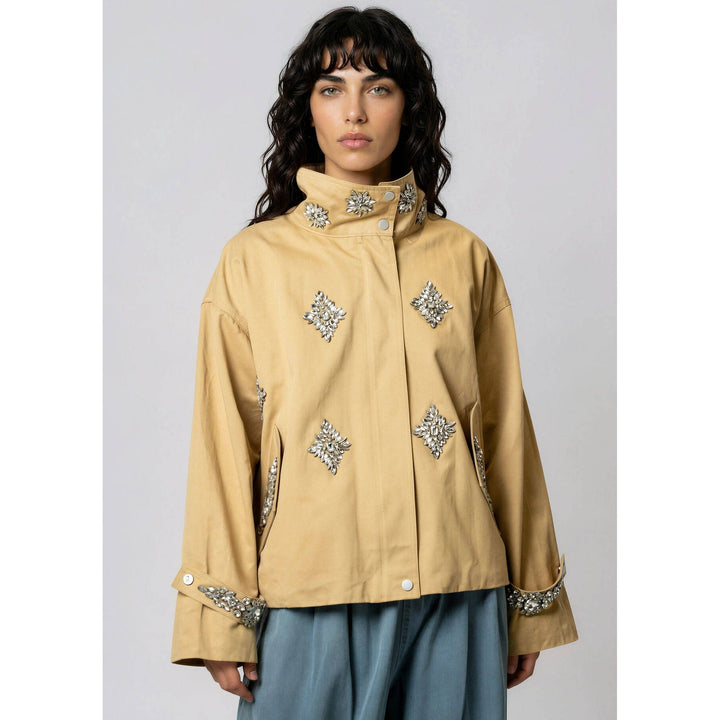 Beige crystal embellished utility jacket with silver rhinestone diamond-shaped details on collar cuffs and front