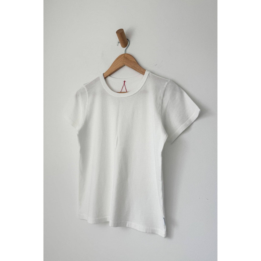 The go-to premium tee white is a white cotton short-sleeved t-shirt with a crew neck and red triangular logo