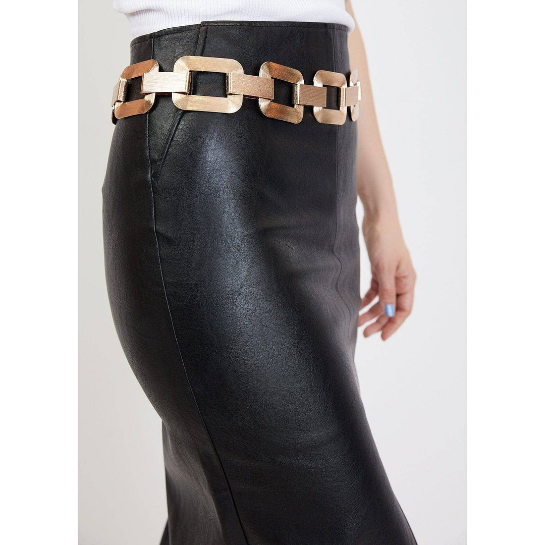 Large link chain belt featuring bold rectangular gold-toned links worn over a black faux leather skirt