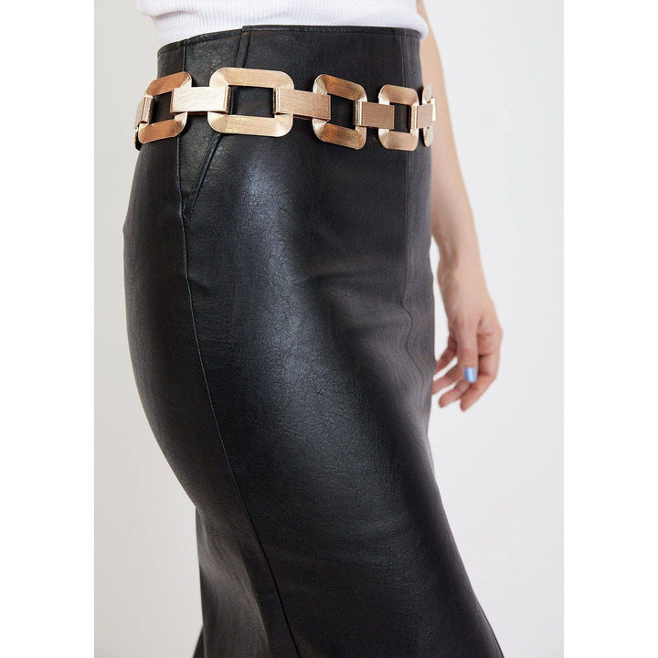 Large link chain belt featuring bold rectangular gold-toned links worn over a black faux leather skirt