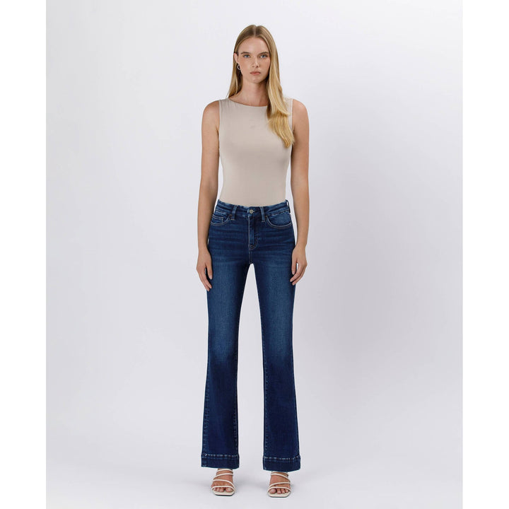 High rise trouser denim featuring dark blue high waisted flared jeans with five pockets and subtle thigh fading