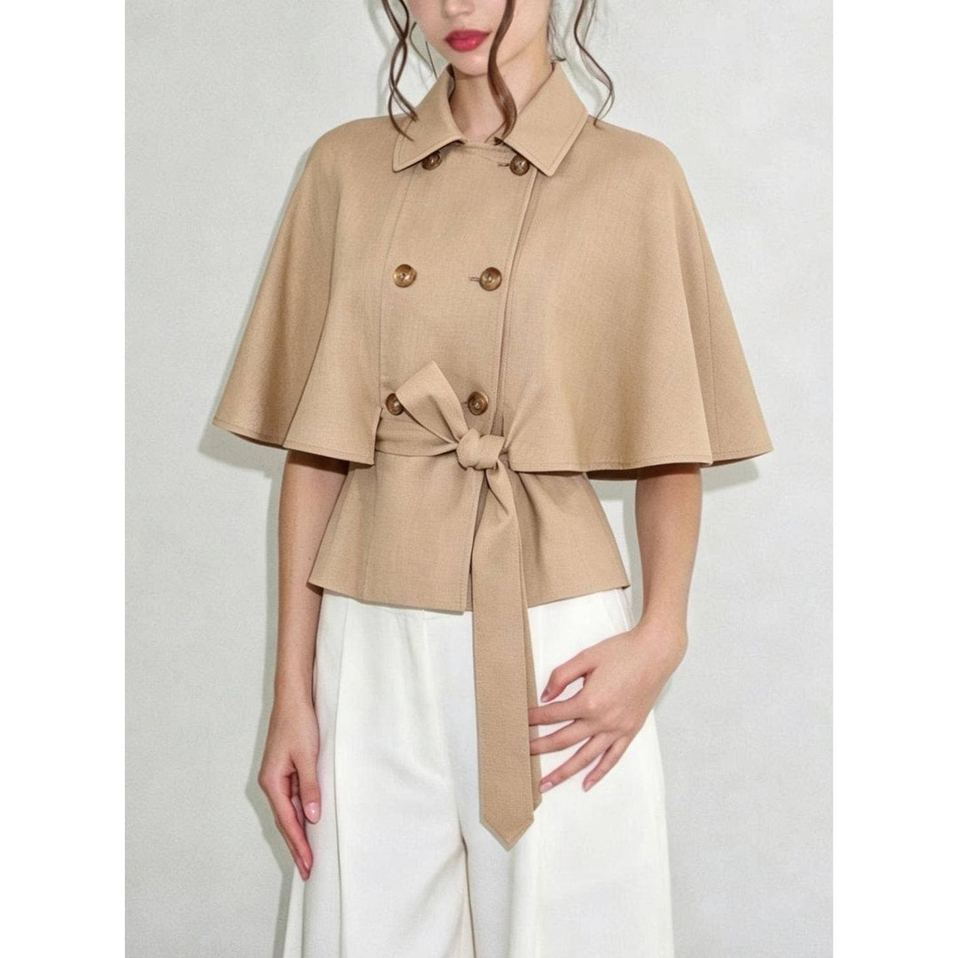 Beige double-breasted cape top with flared sleeves and tied waistband in soft fabric for stylish layering