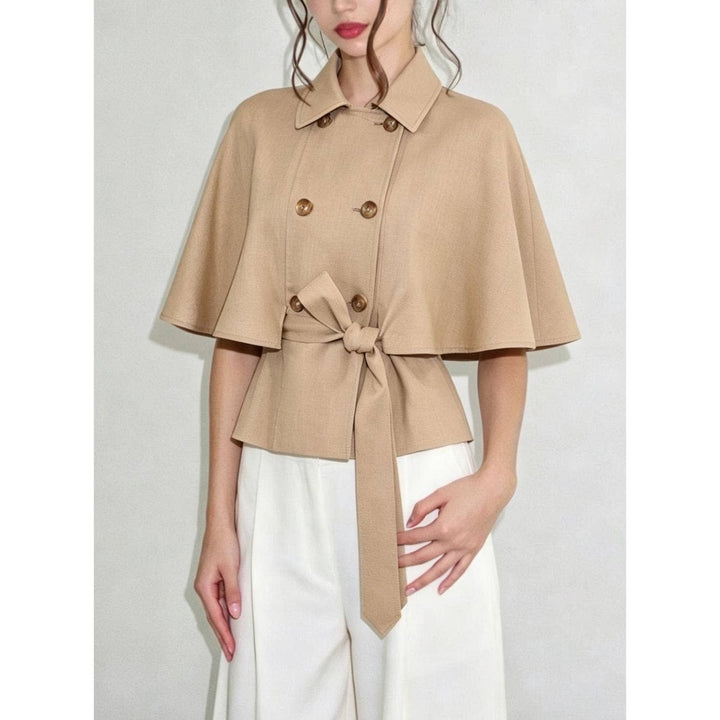 Beige double-breasted cape top with flared sleeves and tied waistband in soft fabric for stylish layering