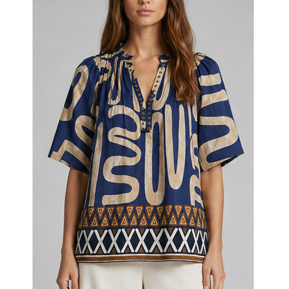 Blue and beige patterned short-sleeved Mediterranean top with bold lettering and geometric trim detail