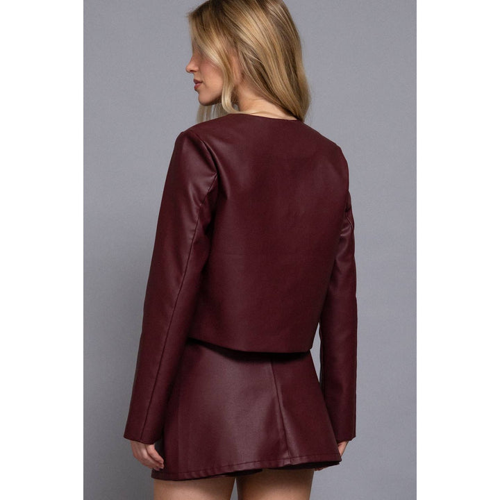 Burgundy cropped jacket made of maroon faux leather featuring long sleeves and a flared skirt design