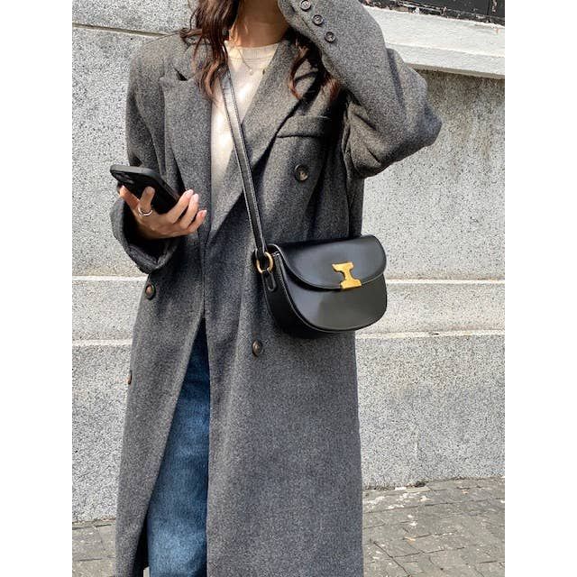 Black leather shoulder bag with gold-tone clasp featuring a sleek and elegant design