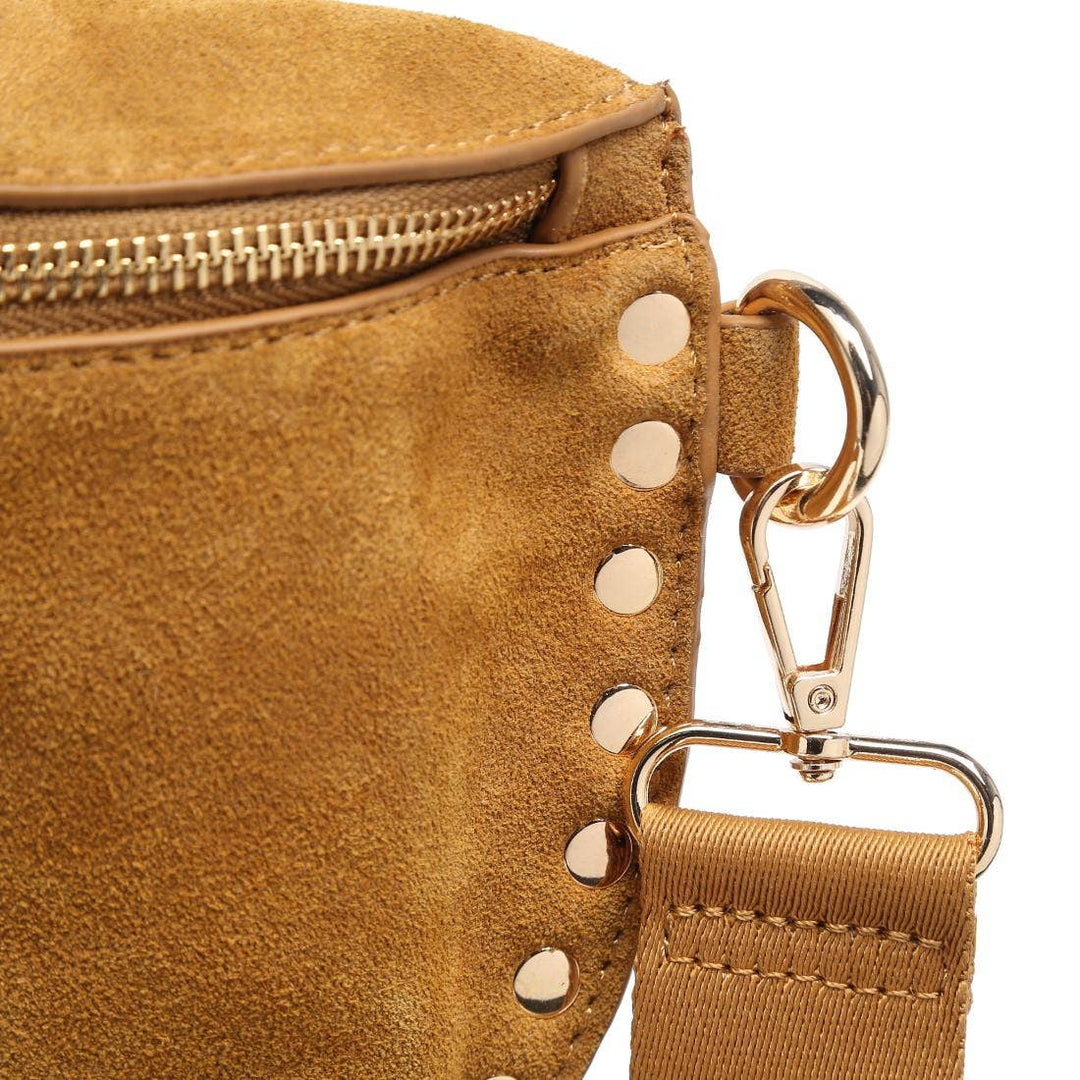 Tan suede gizelle belt bag with gold-tone metal studs and zipper for stylish hands-free wear
