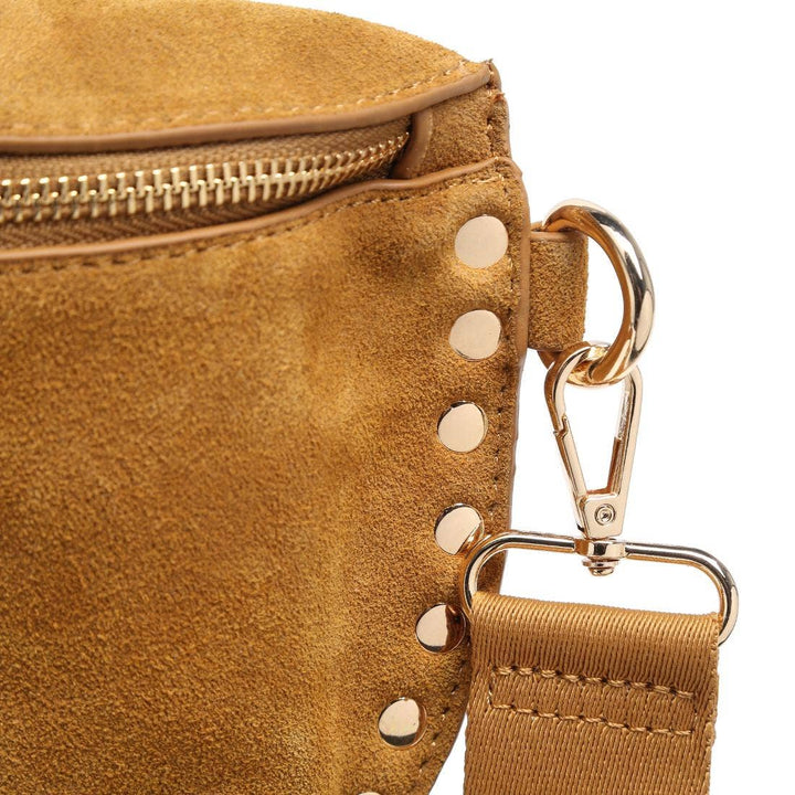 Tan suede gizelle belt bag with gold-tone metal studs and zipper for stylish hands-free wear