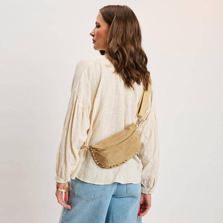 Beige suede gizelle-suede belt bag with gold-tone studded trim and zipper closure for hands-free style