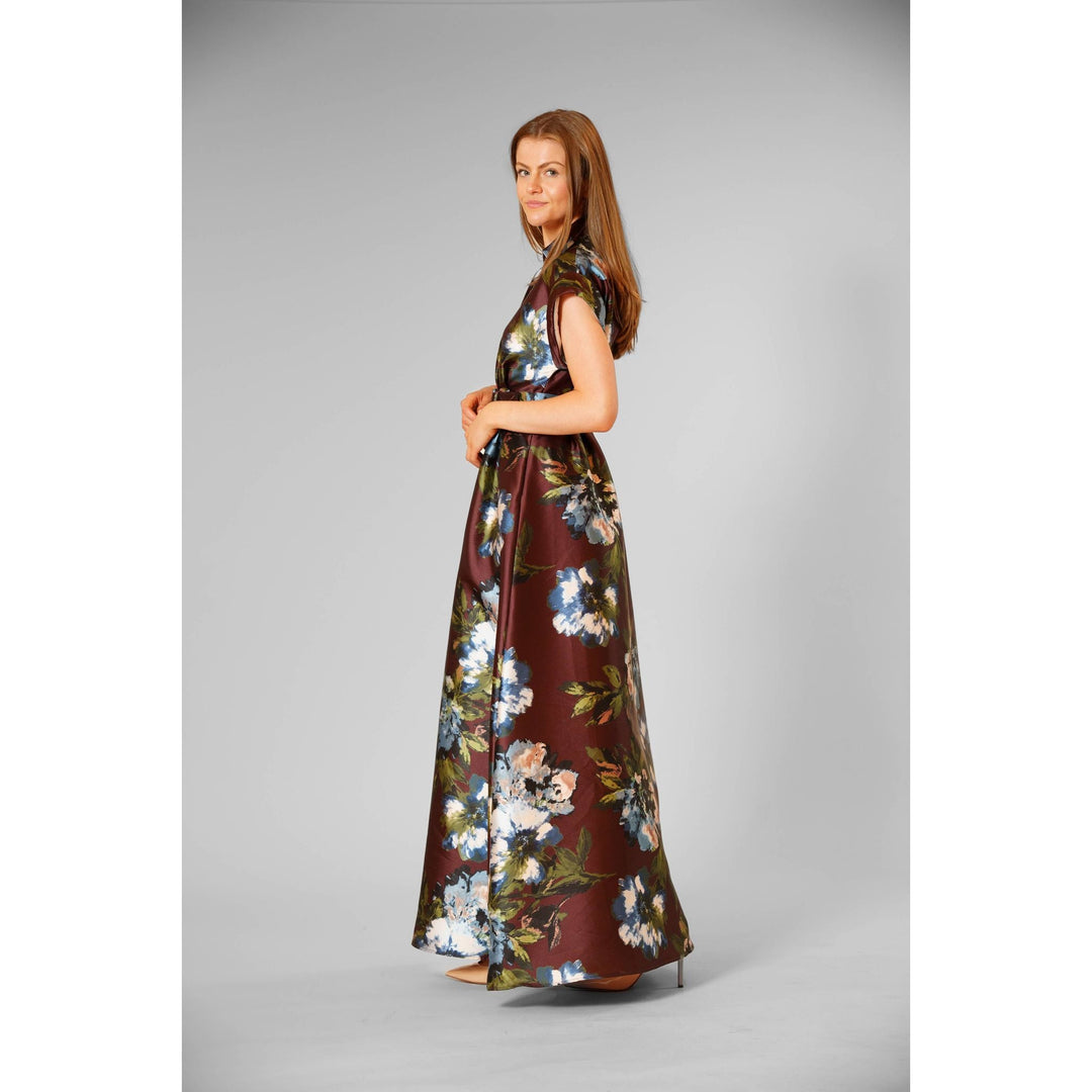 The Pearl Pagoda chocolate twill gown with blue and green floral print, short sleeves, and a waist-defining belt.