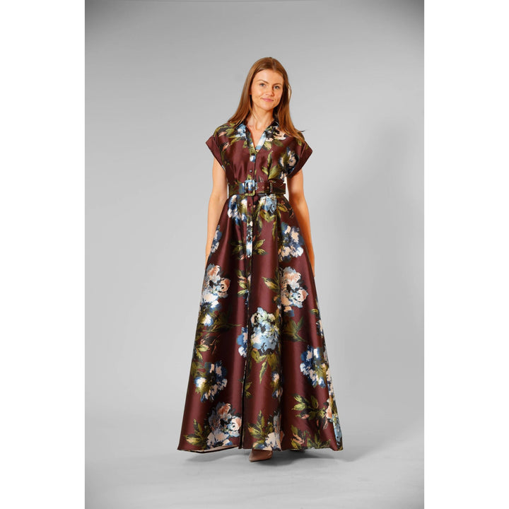 The Pearl Pagoda chocolate twill gown with blue and white floral print, short sleeves, and a belted waist.
