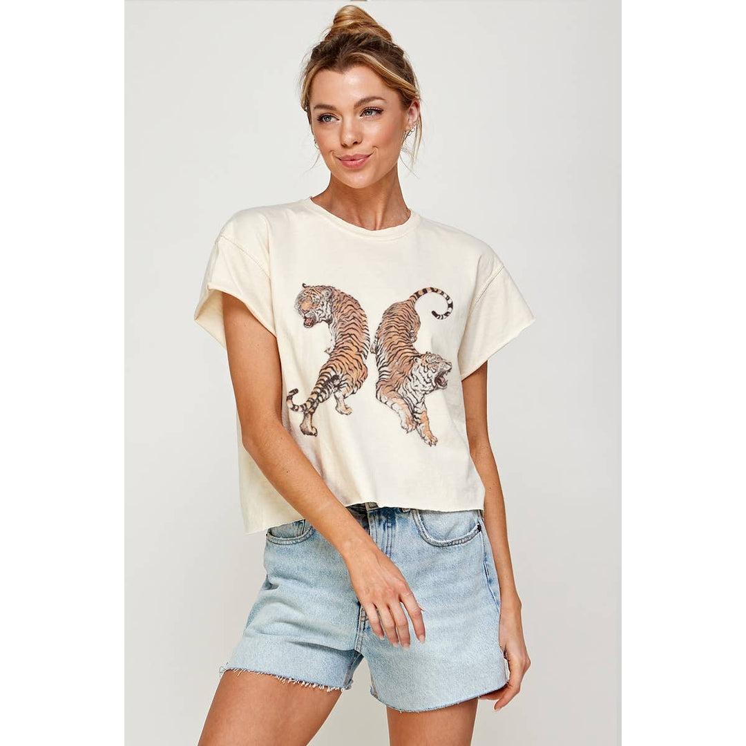 A woman wearing The Pearl Pagoda cream-colored cropped ring-spun cotton tee featuring a two tigers graphic print.
