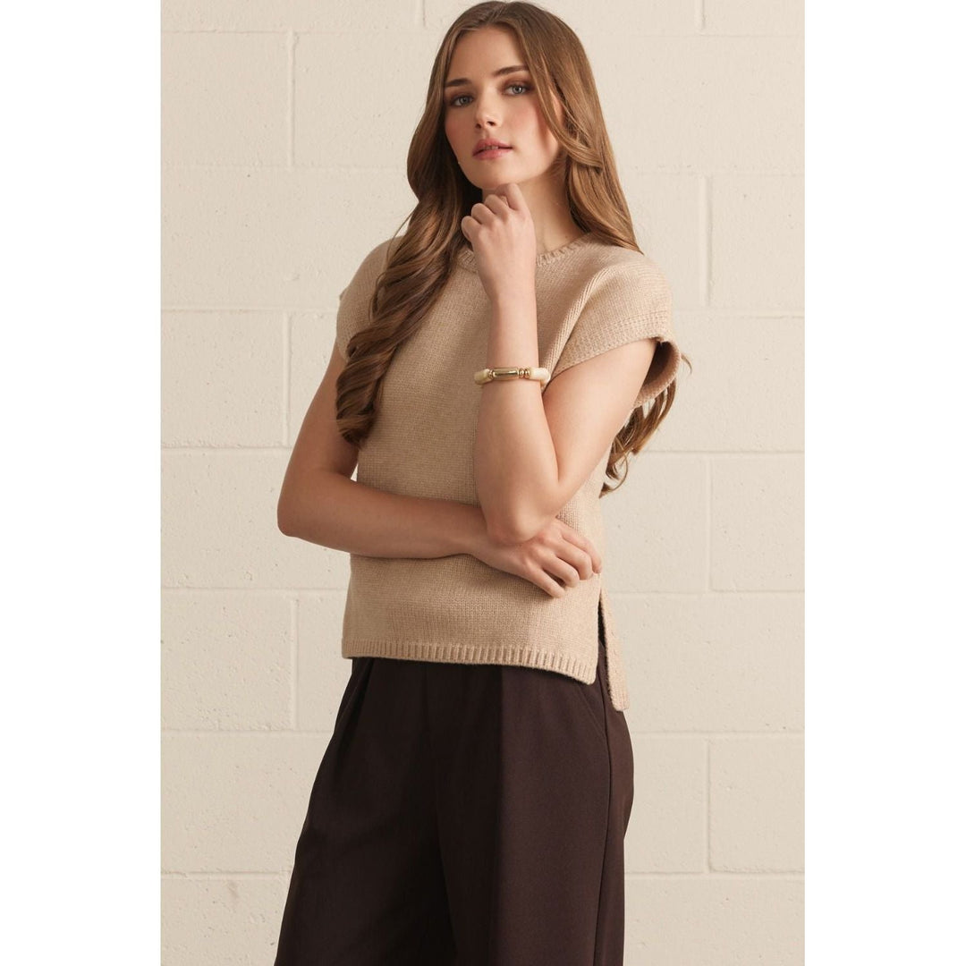 Model wearing The Pearl Pagoda latte-colored lightweight viscose crew neck sweater with cap sleeves and side slits.