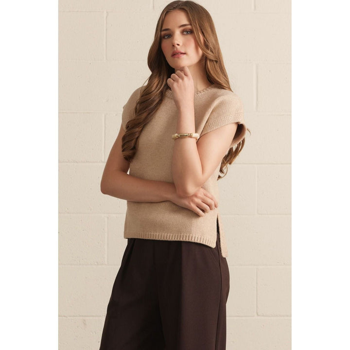 Model wearing The Pearl Pagoda latte-colored lightweight viscose crew neck sweater with cap sleeves and side slits.