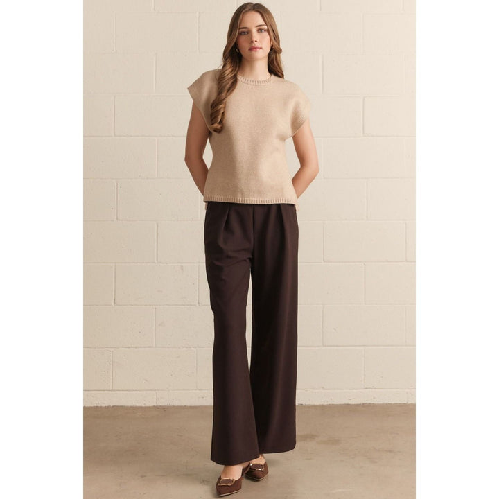 Model wearing The Pearl Pagoda Latte Sweater, a lightweight viscose knit with crew neck and cap sleeves in beige.