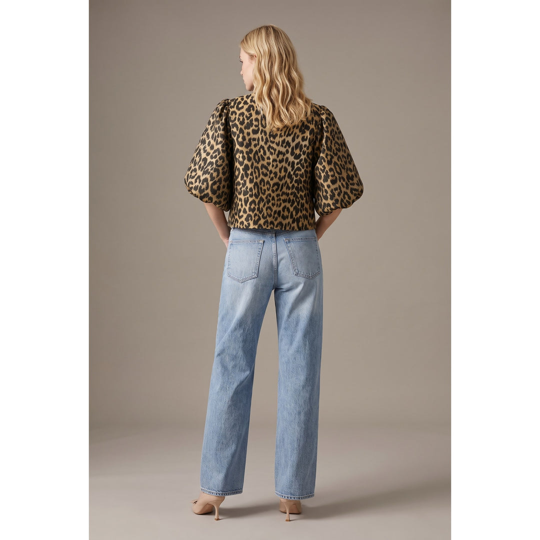 The Pearl Pagoda leopard print cropped jacket with balloon sleeves worn with light wash jeans, back view.