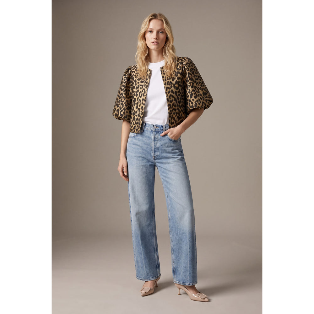 The Pearl Pagoda leopard print cropped jacket with balloon sleeves worn by a model with jeans and heels
