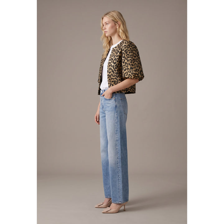 The Pearl Pagoda leopard print cropped jacket with balloon sleeves worn by a model with jeans and heels.