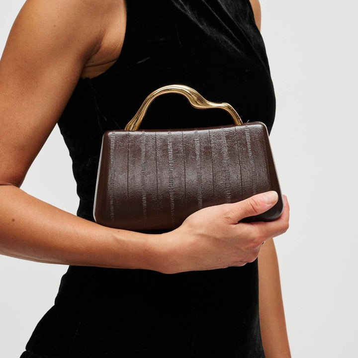 The Pearl Pagoda Nichelle clutch in espresso brown with a sculptural gold metal handle and vertical embossed texture.